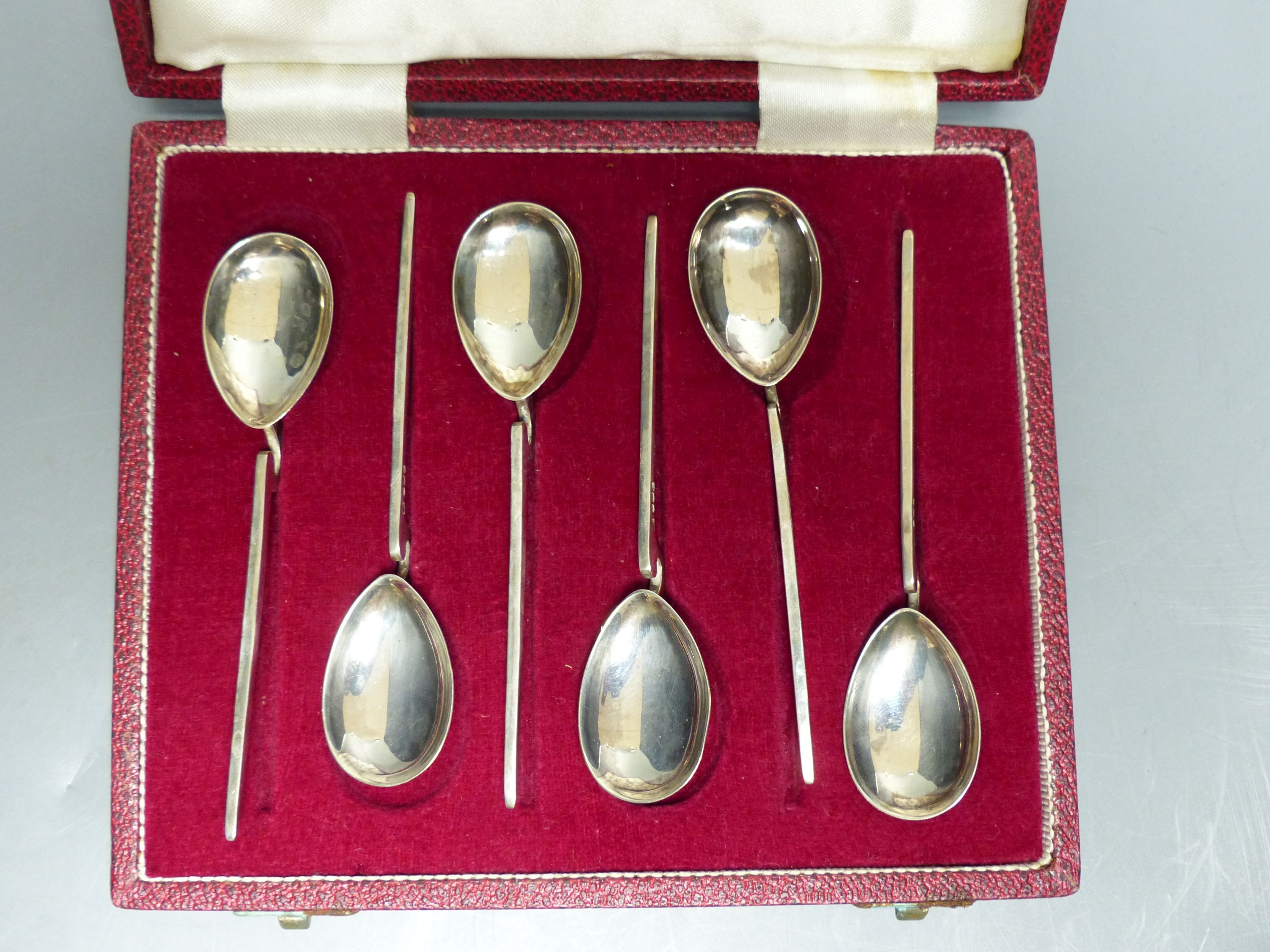 A modern case set of six silver preserve spoons, Sheffield, 1972 and a similar cased set of eight silver coffee spoons.